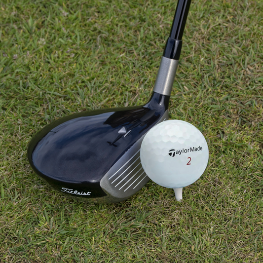 Used TaylorMade TP5x golf ball on the course, white