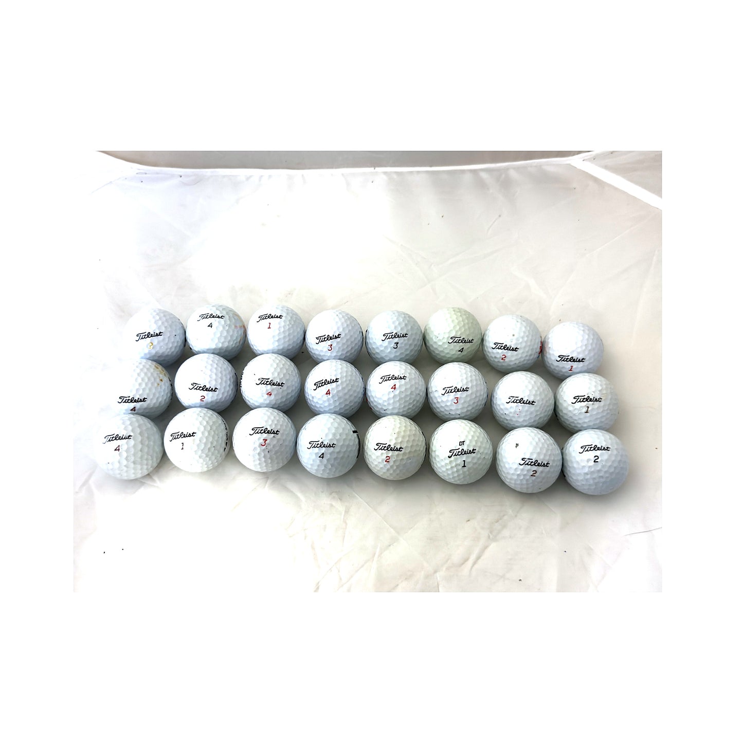 All 24 used Titleist mix golf balls laid out and counted, Value (3A) grade